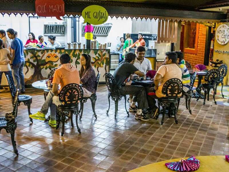 Smiling volunteer at Seva Cafe